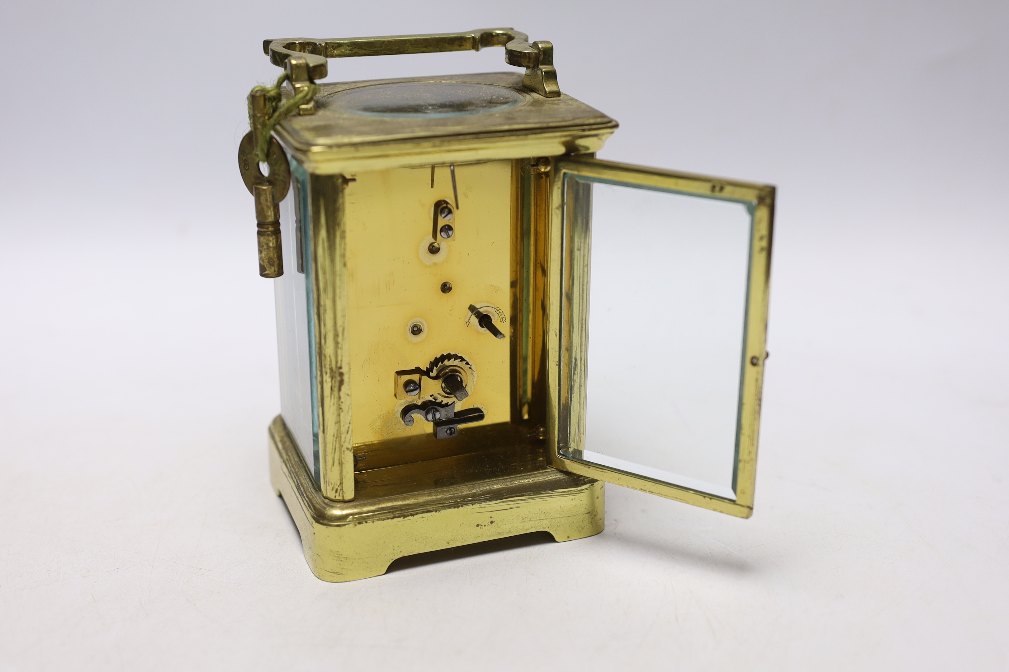 A brass carriage timepiece with enamel dial, 18cm high